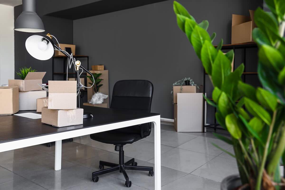 Workers relocating office furniture and equipment